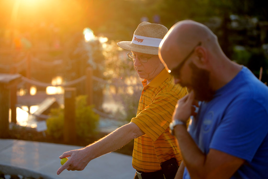 Marvin Twenner, left, and Dustin Doyle discuss their game of mini golf